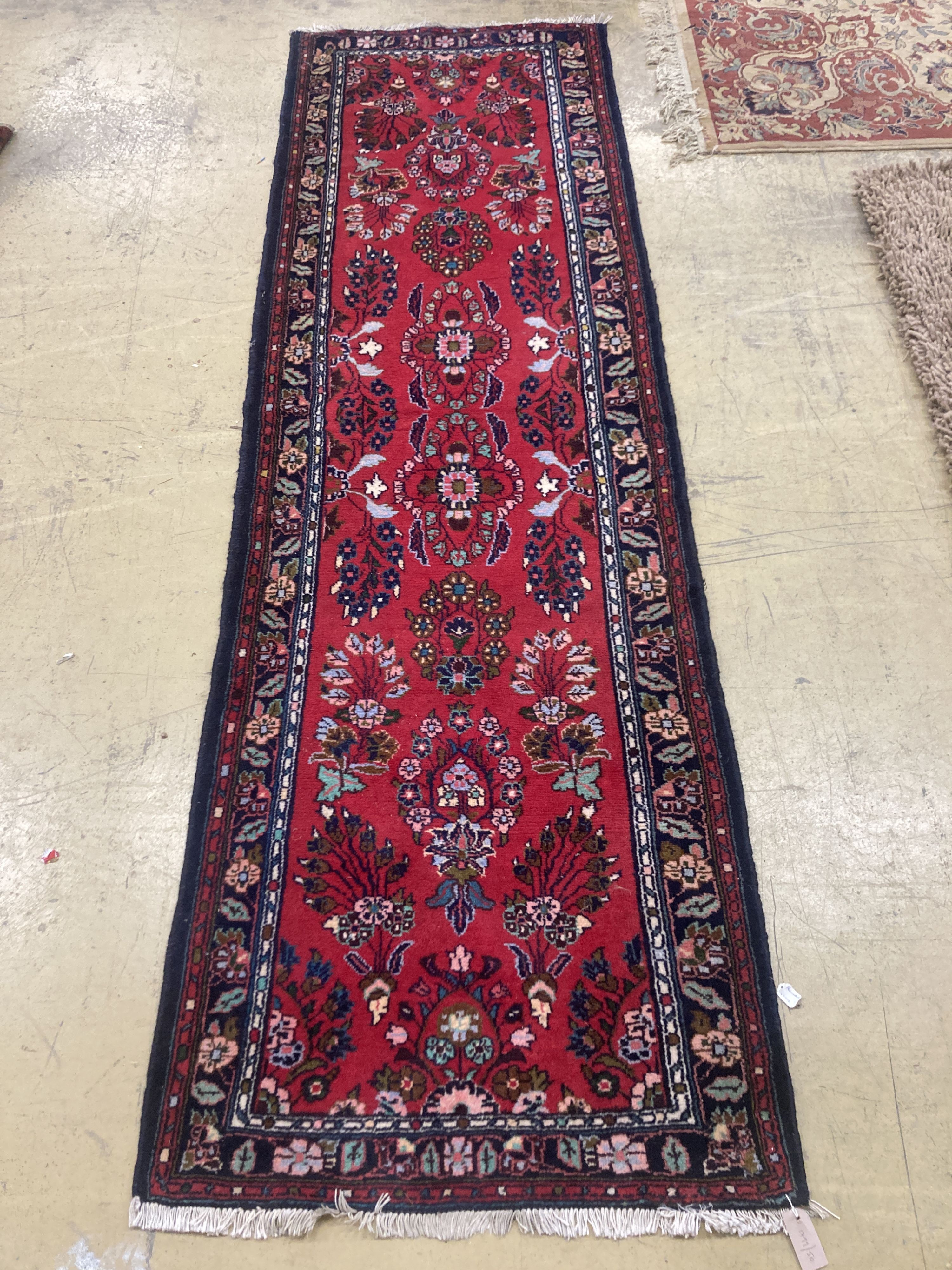 A Hamadan red ground runner with floral design, 280 x 84cm